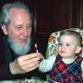 Lighting a candle with his adopted daughter Techi